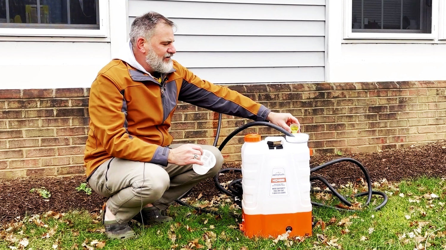 A man cleaning a backpack sprayer