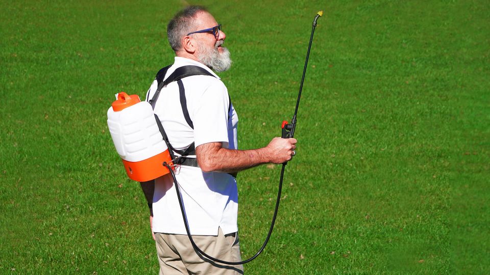 A man using PetraTools HD2000 , a 2 gallon battery powered backpack sprayer